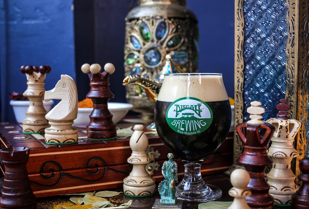 Glass of beer and chess figures decoration