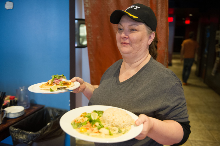 Server brings food out at Blue Dream Curry House